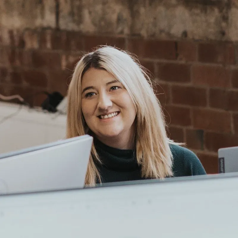 Zara, owner of Base2Base Bookkeeping, smiling while providing expert guidance on Xero accounting setup in a modern office setting.