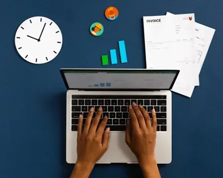 xero worker Person typing on laptop with financial charts, clock, and invoices, illustrating efficient bookkeeping and Xero setup for small businesses.